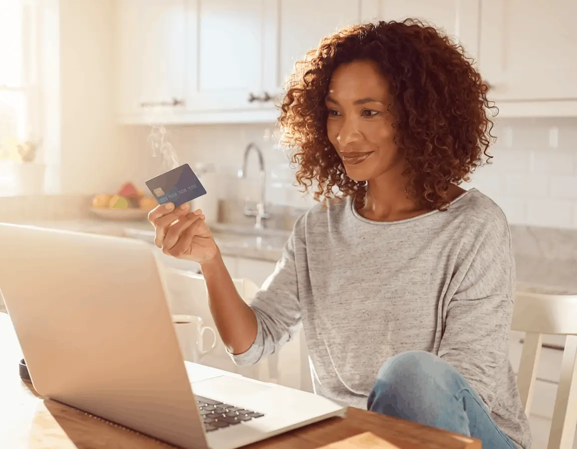 Woman completing online purchase with credit card